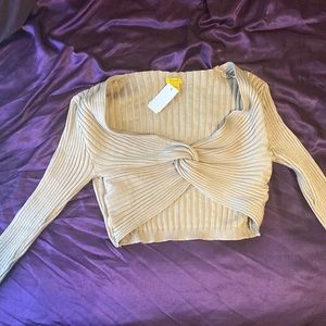 Long sleeve beige colored crop top.